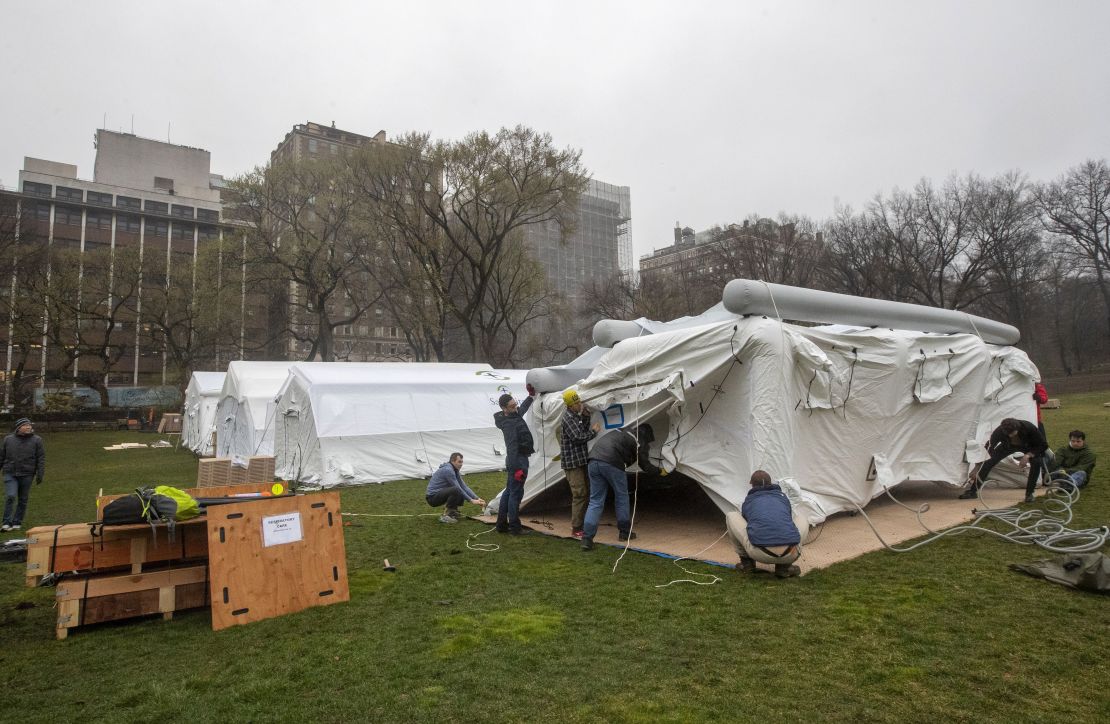 A Samaritan's Purse crew works on building an emergency field hospital equipped with a respiratory unit in New York's Central Park across from the Mount Sinai Hospital, Sunday, March 29, 2020.