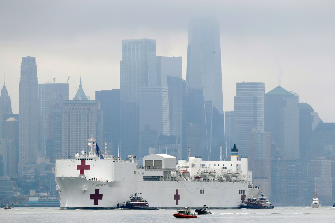 The Navy hospital ship USNS Comfort passes lower Manhattan on its way to docking in New York, Monday, March 30, 2020.