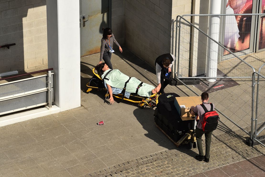 Medical staff wheel a model of a fake patient into the ExCeL London exhibition centre, which has been converted into field a massive hospital to help the UK's coronavirus response.