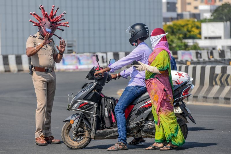 India lockdown Police officer wears a coronavirus helmet to warn people to stay inside