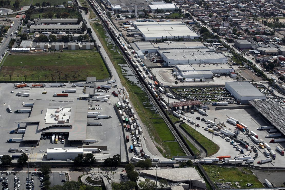 Commercial freight trucks line up to cross into the United States from Mexico through the U.S. Customs and Border Protection - Otay Mesa Port of Entry in San Diego, California.