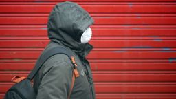 A person wearing a face mask as a preventive measure against the COVID-19 disease walks in Vilanova i la Geltru on March 30, 2020. - Spain confirmed another 812 deaths in 24 hours from the coronavirus today, a slight decline on the previous day's toll, bringing the total number of deaths to 7,340. The country, which has the world's second most deadly outbreak after Italy, recorded 838 deaths from the pandemic yesterday, its third straight daily record for coronavirus deaths. (Photo by LLUIS GENE / AFP) (Photo by LLUIS GENE/AFP via Getty Images)