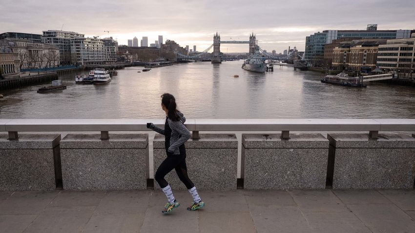 LONDON, ENGLAND - MARCH 30: A woman crosses London Bridge during what would usually be the busy pre-9am rush-hour on March 30, 2020 in London, England. The Coronavirus (COVID-19) pandemic has spread to many countries across the world, claiming over 30,000 lives and infecting hundreds of thousands more. (Photo by Leon Neal/Getty Images)