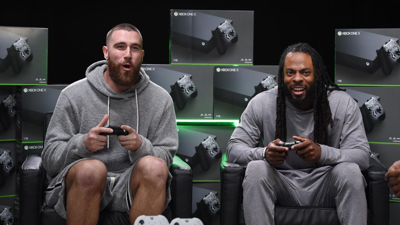 Sherman plays Xbox alongside Kansas City Chiefs tight-end Travis Kelce before the pandemic.