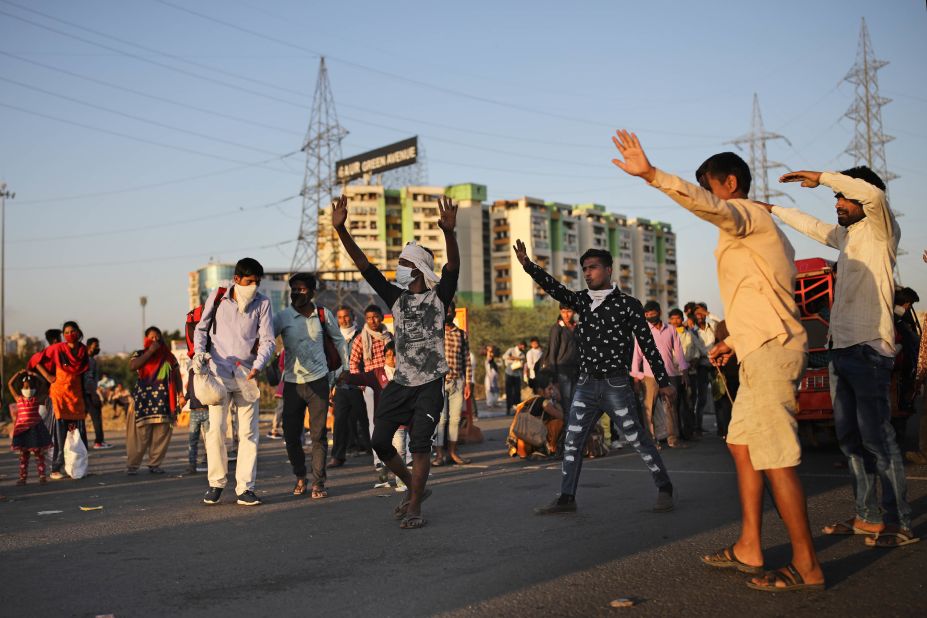 People try to hail a bus in New Delhi.