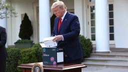 WASHINGTON, DC - MARCH 30:  U.S. President Donald Trump takes a new COVID-19 test kit developed by Abbott Labs out of its box during the daily coronavirus briefing at the Rose Garden of the White House on March 30, 2020 in Washington, DC. The United States has updated its guidelines to U.S. citizens to maintain current social distancing practices through the end of April after the number of reported coronavirus (COVID-19) deaths doubled to over 2,000 nationwide within two days.  (Photo by Win McNamee/Getty Images)