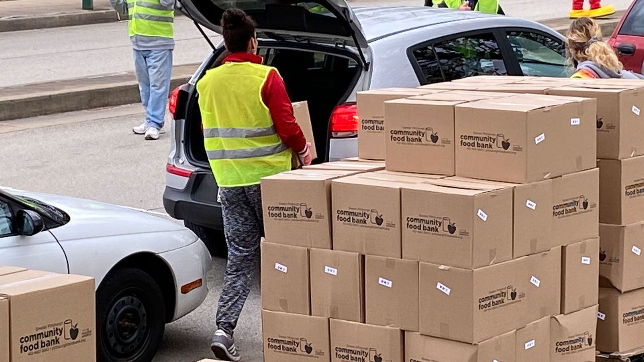 Cars lined up to receive groceries from the Greater Pittsburgh Community Food Bank on Monday.