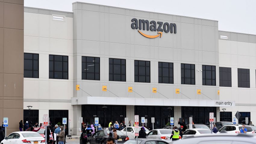 Amazon workers at Amazon's Staten Island warehouse strike in demand that the facility be shut down and cleaned after one staffer tested positive for the coronavirus on March 30, 2020 in New York. - Amazon employees at a New York City warehouse walk off the job March 30, 2020, as a growing number of delivery and warehouse workers demand better pay and protections in the midst of the COVID-19 pandemic.