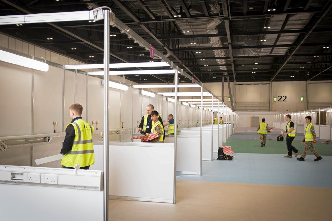 Members of the military and private contractors, seen Monday, help to prepare the ExCel centre in London to become a field hospital to be known as the NHS Nightingale Hospital.