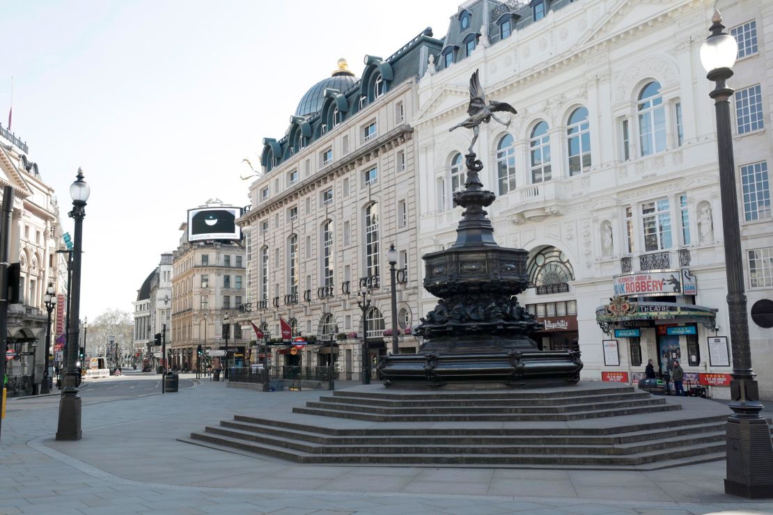 The statue of Eros, whose surrounding steps are normally packed with tourists, is deserted at Piccadilly Circus on the first day of lockdown.