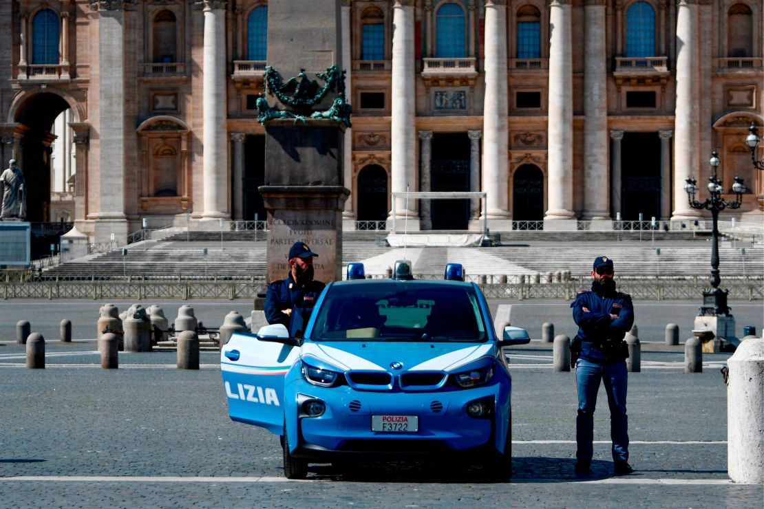 Italian police officers stand guard at a closed St. Peter's Square in the Vatican.