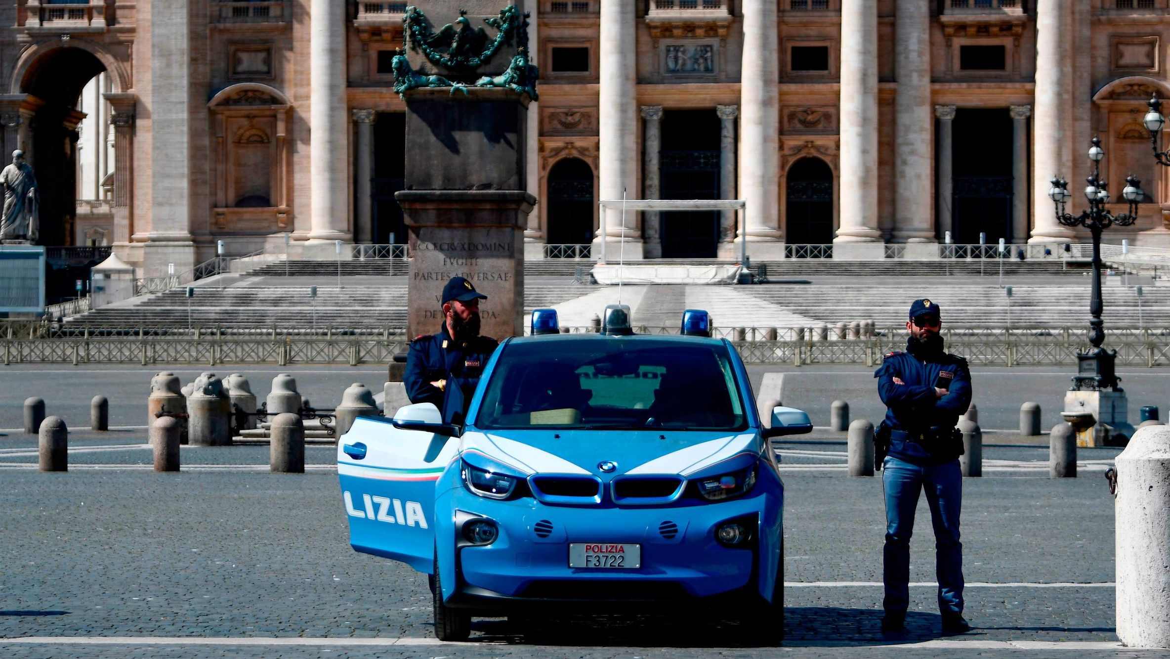 Italian police officers stand guard at a closed St. Peter's Square in the Vatican.