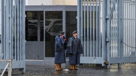 Swiss Guards stand at an entrance gate to the Vatican during Italy's lockdown.