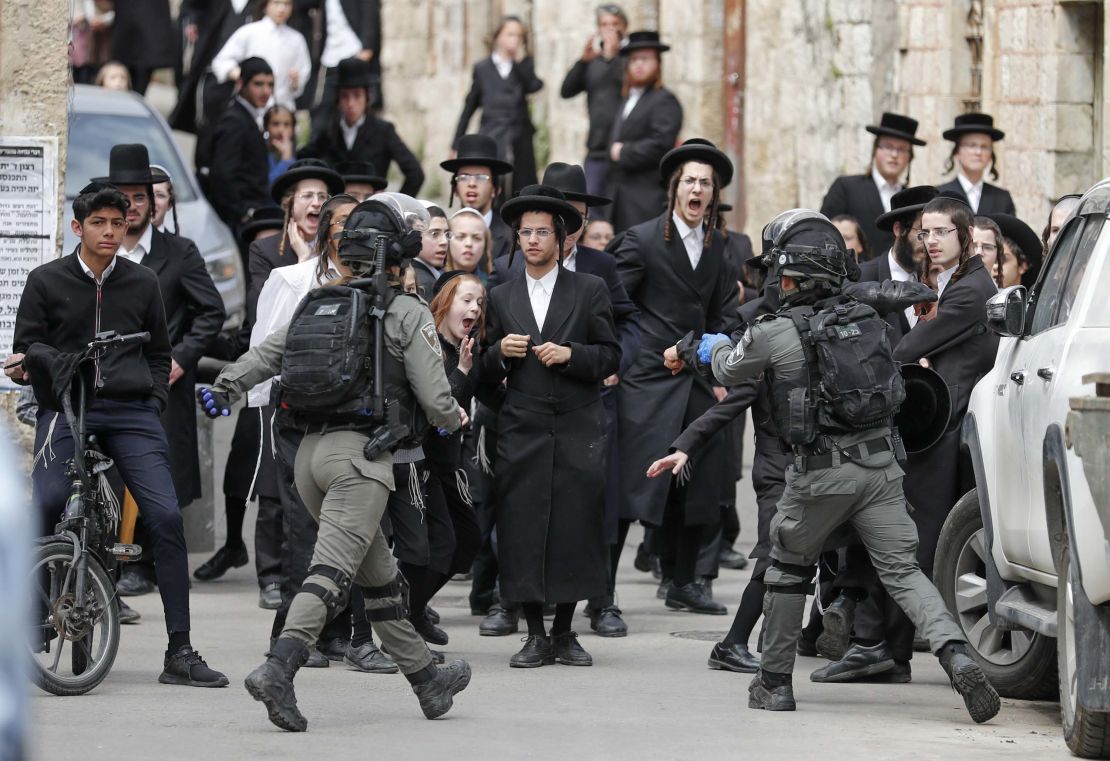 Israeli security forces arrest an ultra-Orthodox Jewish man as they close a synagogue in Jerusalem on Monday.