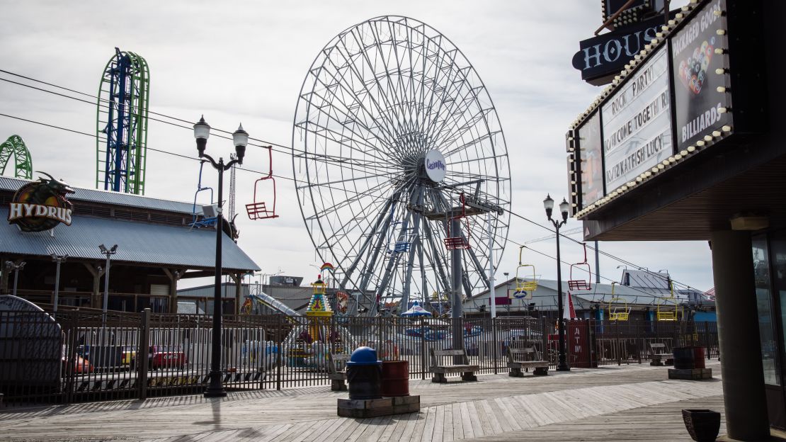 Amusement rides stand idle near an empty boardwalk in Seaside Heights, New Jersey, on Friday.