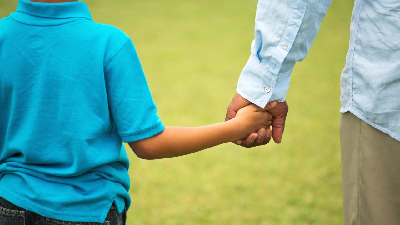 father son holding hands STOCK