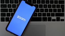 ANKARA, TURKEY - MARCH 30 : Logo of Zoom, remote conferencing services company for mobile application and desktop is seen with writing of COVID-19 coronavirus disease in back of it, in Ankara, Turkey on March 30, 2020. (Photo by Hakan Nural/Anadolu Agency via Getty Images)