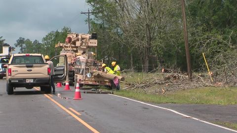 Workers in George County, Mississippi clean up debris on March 31, 2020.