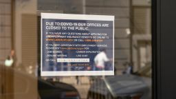 View of Brooklyn office of NYS Department of Labor as unemployment claims in USA soared to 3.3 million in week ended March 21 because of COVID-19 pandemic. Sign on the doors asking people to apply for unemployment online.