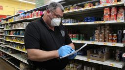 Major Bobby Reed from the Bourbon County Sheriff's Department in Kansas buys and delivers groceries for vulnerable residents during the coronavirus pandemic, on March 30, 2020.