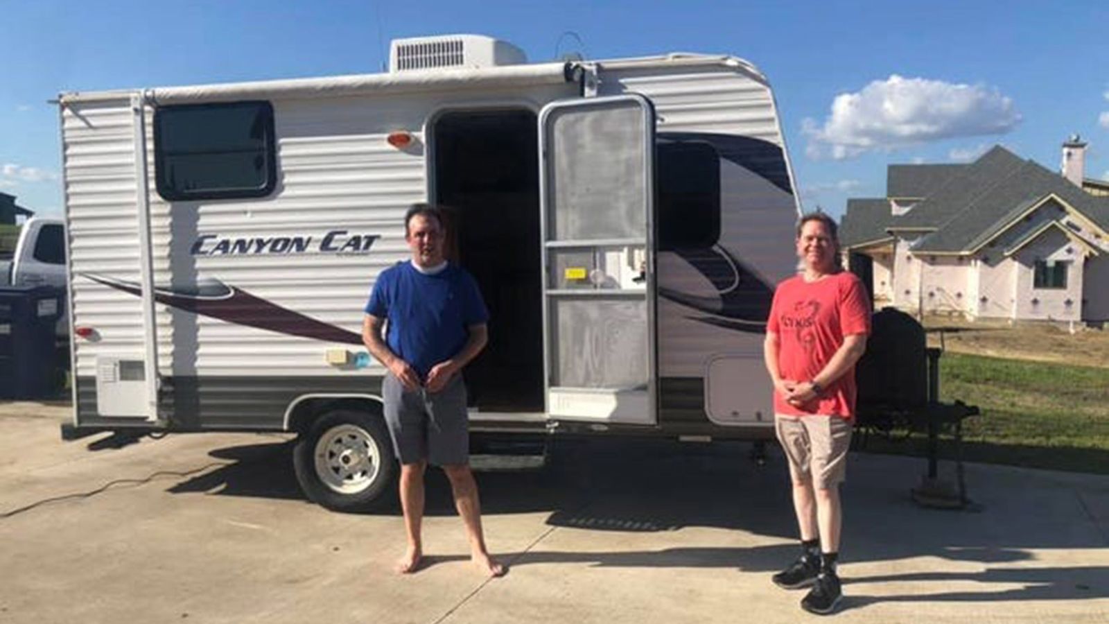 Dr. Jason Phillips (left) and Dr. Craig Reese Brockman with a donated camper that Brockman will use to prevent the risk of passing along the coronavirus to his family. 