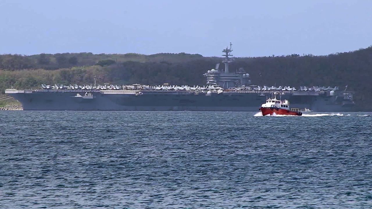 USS Theodore Roosevelt aircraft carrier sits on the outskirts of Apra Harbor, Guam, on April 1. At least 70 sailors have tested positive for coronavirus aboard the aircraft carrier.