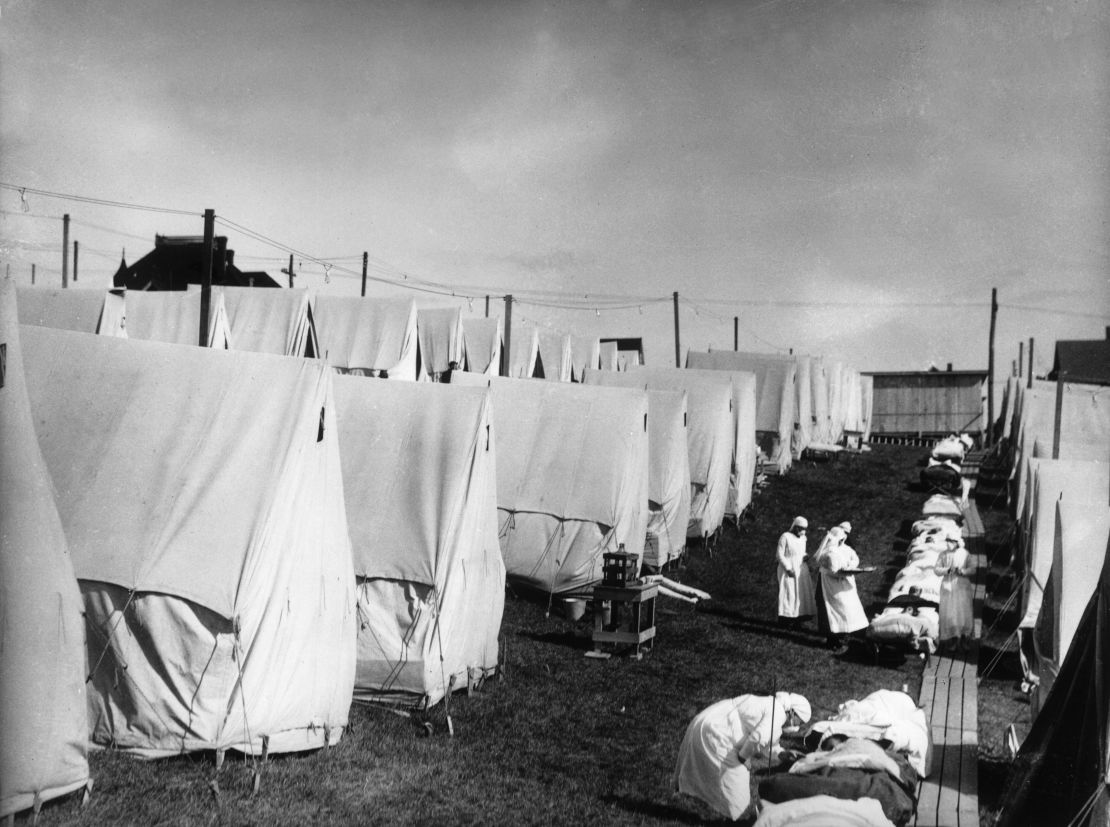 Nurses care for victims of the influenza pandemic outdoors in 1918 in Lawrence, Massachusetts.
