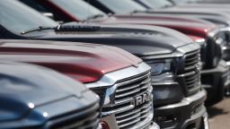 In this Sunday, March 15, 2020, photograph, a long row of unsold 2020 Ram pickup trucks sits at a Dodge dealership in Littleton, Colo. (AP Photo/David Zalubowski)