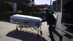 William Samuels delivers caskets to the Gerard Neufeld Funeral Home, Friday, March 27, 2020 during the coronavirus pandemic in the Queens borough of New York. A funeral home in New York City has seen a steady stream of people who have died from the coronavirus. In just the past week, the funeral home has had services for almost a dozen people who have died, and is expecting more. For those mourning loved ones, funerals in the age of self-quarantine and social distancing are a far cry from the rituals of collective mourning that took place even a few weeks ago. (AP Photo/Mark Lennihan)