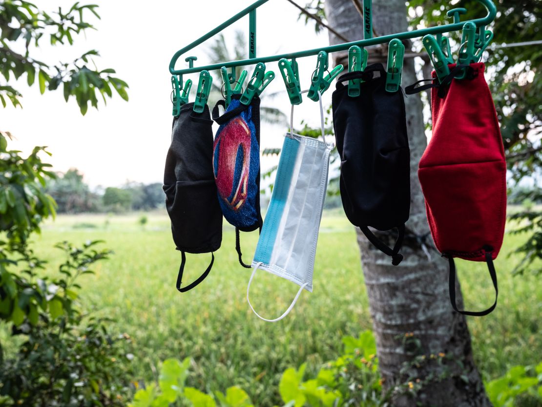 April Abrias' facemasks are hung out to dry after being washed so they can be reused.