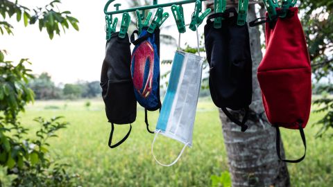 April Abrias' facemasks are hung out to dry after being washed so they can be reused.