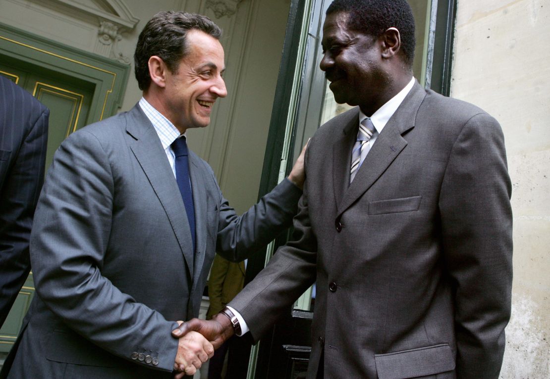 Diouf shakes hands with the then French Interior Minister Nicolas Sarkozy.