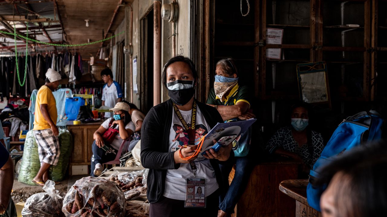 Filipina nurse April Abrias in a crowded vegetable market while checking on patients showing symptoms of Covid-19.