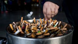 In this photo taken on February 28, 2017, a man grinds out his cigarette in an ashtray at a railway station in Shanghai.  
Shanghai widened its ban on public smoking March 1 as China's biggest city steps up efforts to stub out the massive health threat despite conflicts of interest with the state-owned tobacco industry.  / AFP / Johannes EISELE        (Photo credit should read JOHANNES EISELE/AFP via Getty Images)