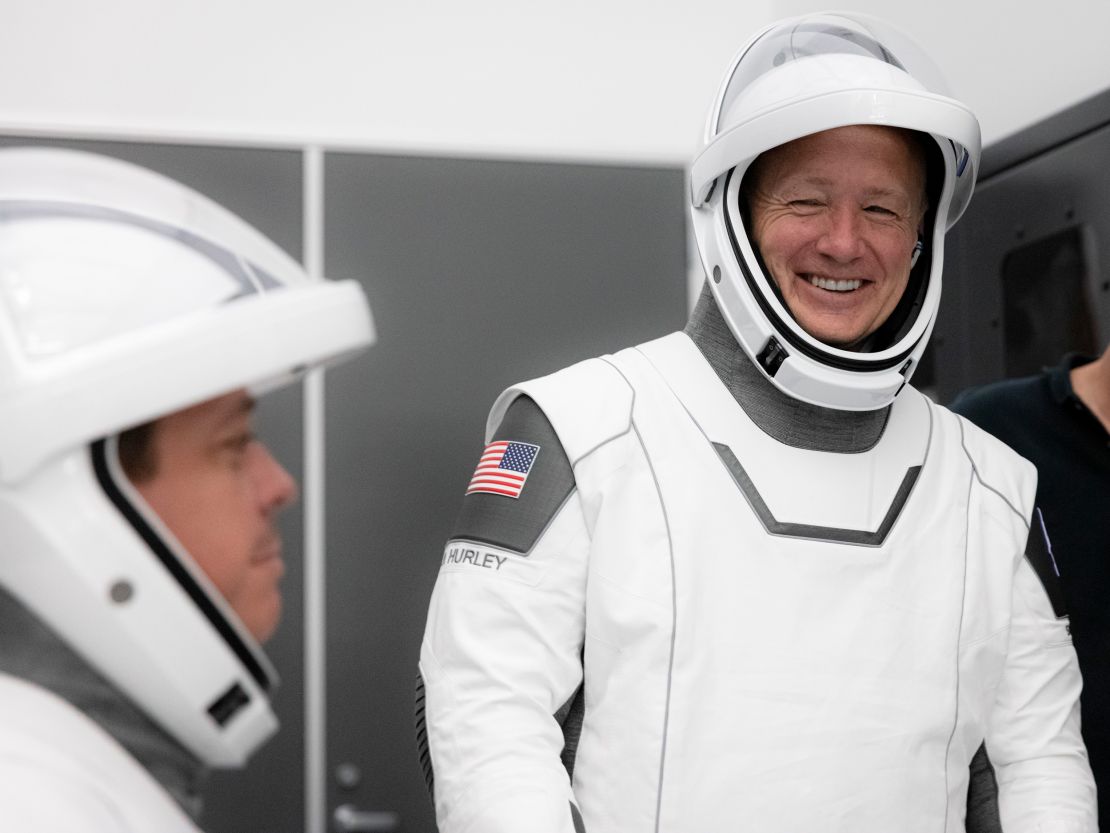 NASA astronauts Bob Behnken (left) and Doug Hurley participate in SpaceX's flight simulator.
