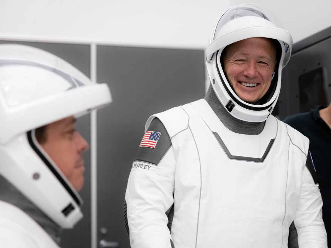 NASA astronauts Bob Behnken (left) and Doug Hurley participate in SpaceX's flight simulator.