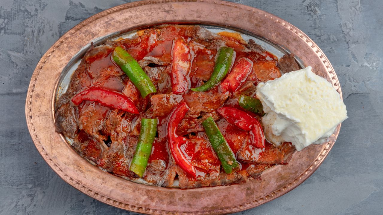<strong>Iskender kebab:</strong> This meat dish is comprised of doner kebab, prepared from grilled lamb, that's topped with hot tomato sauce, placed over pita bread and coated with melted butter and yogurt.