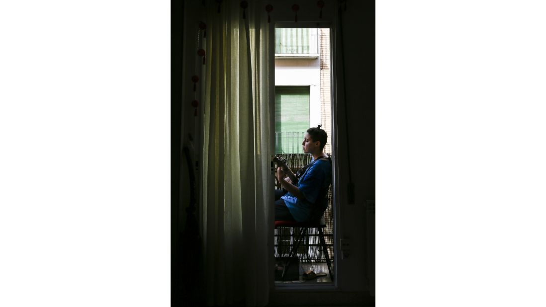 <strong>Zaragoza, Spain:</strong> Roommate and sister Karimeh Daneshmandi serenades from her bedroom balcony, her go-to form of lockdown R&R.