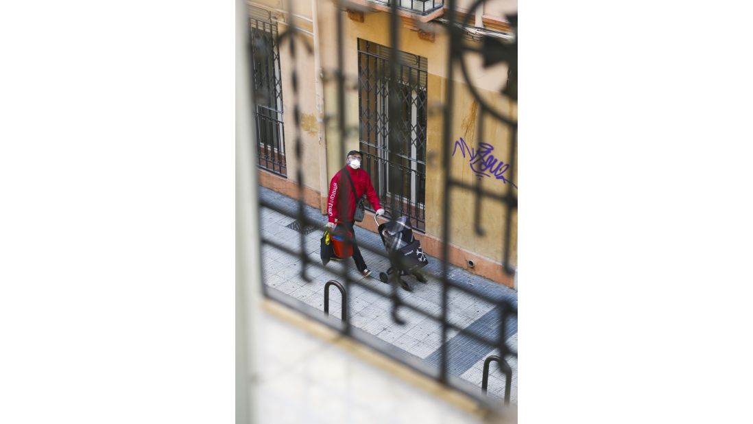 <strong>Zaragoza, Spain:</strong> Photographer catches a glimpse of a man with his mask, gloves, cleaning buckets, and grocery shopping cart through her bedroom mirror.