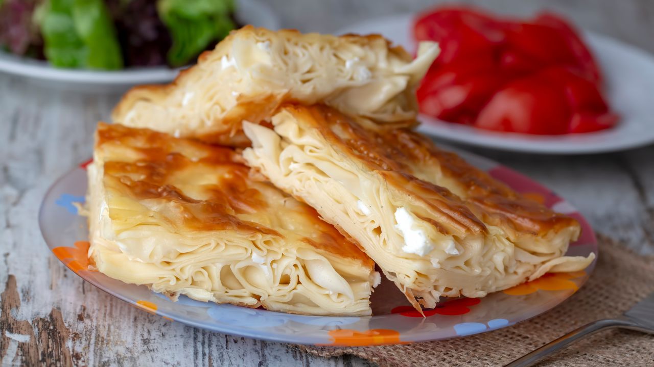 This savory pastry is made by layering sheets of a dough named 