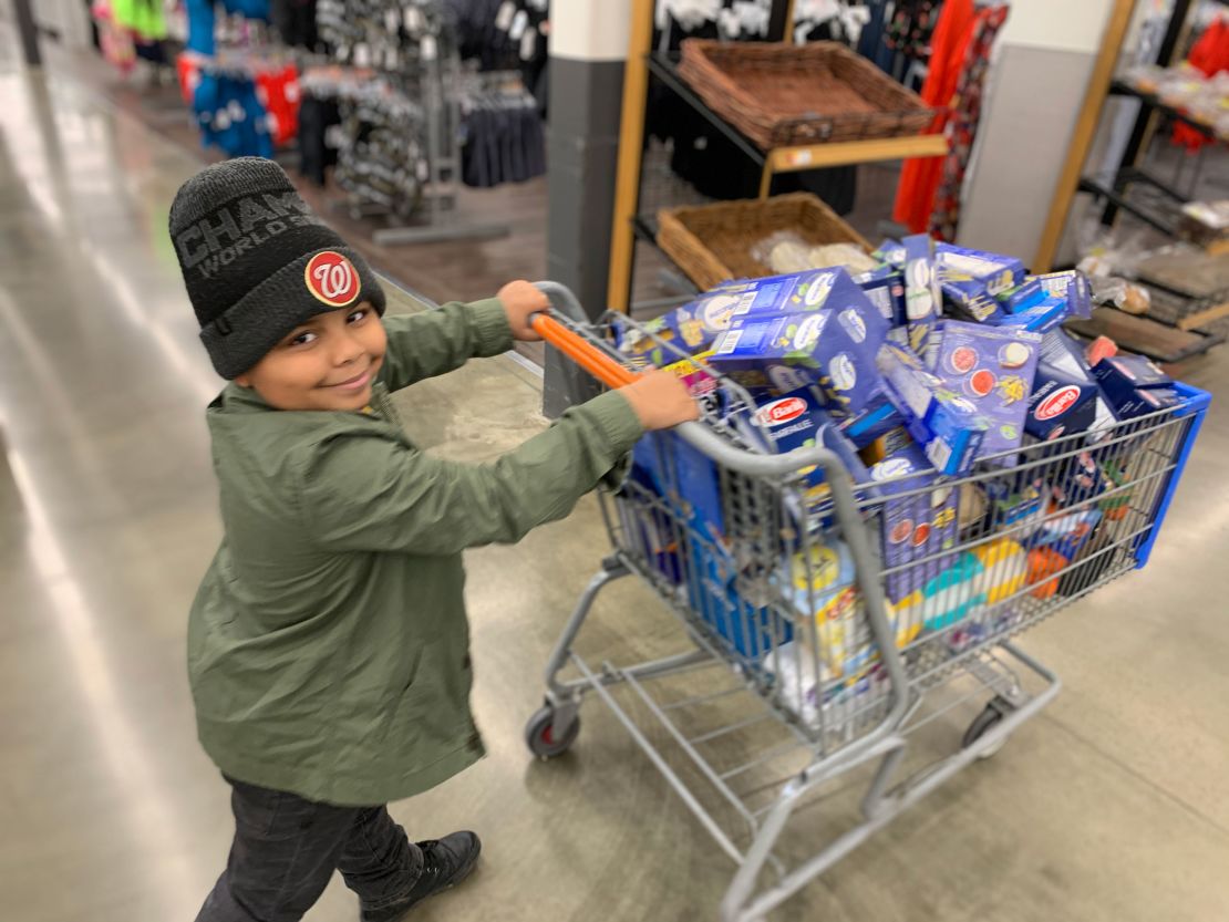 Cavanaugh Bell, 7, shops for items to make care packages for the elderly.