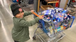 7-year-old Cavanaugh Bell shops for items to put in care packages for the elderly.