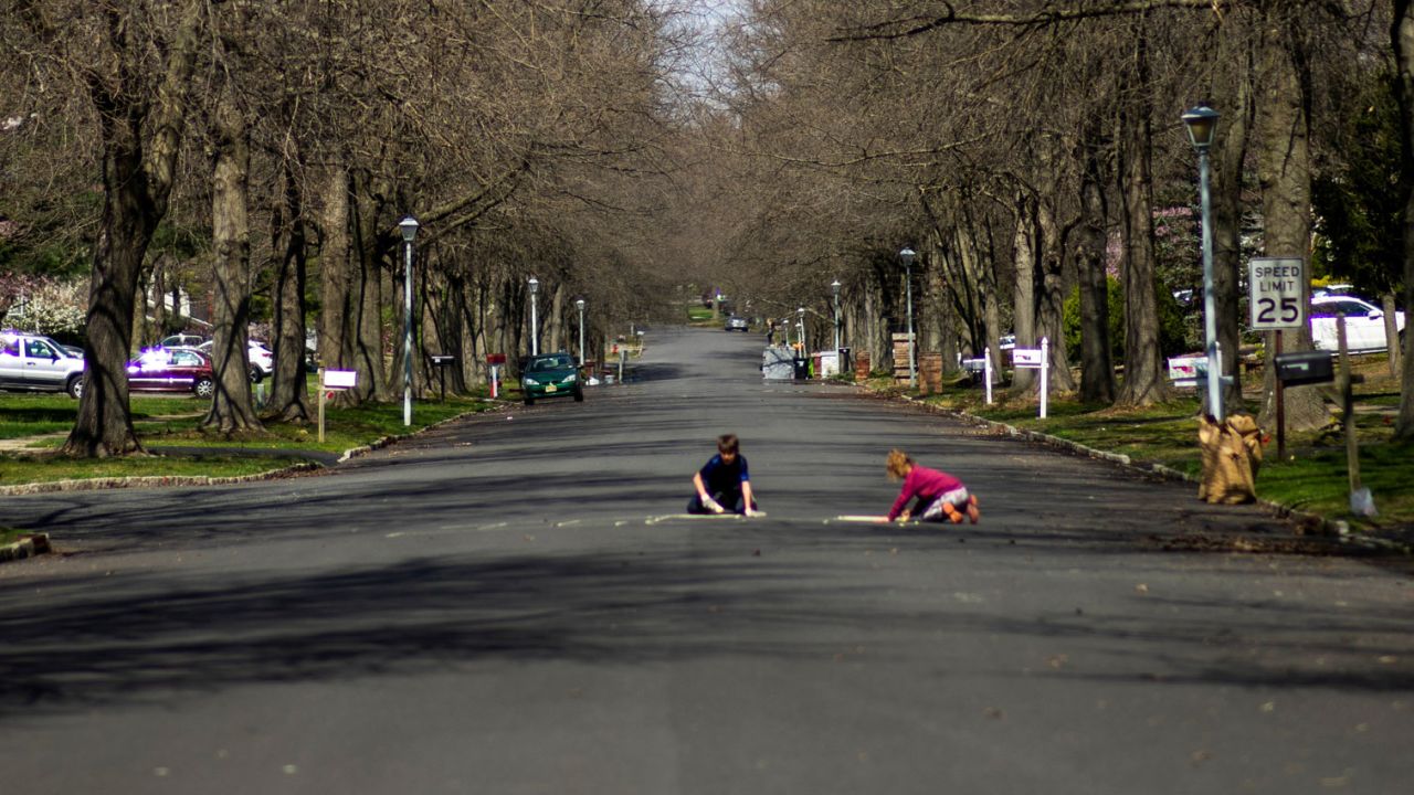 Children play on a residential street in Matawan, New Jersey on April 1, 2020.