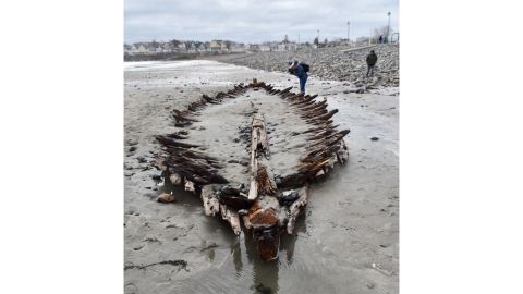 A person photographs a shipwreck's remains after the nor'easter that battered the New England coast made it visible Monday, March 5, 2018, on Short Sands Beach in York, Maine. 