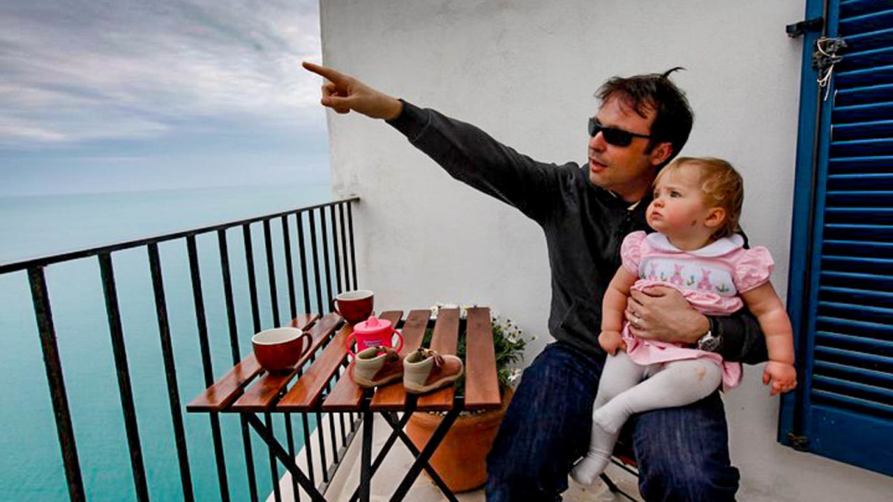 <strong>Look over there:</strong> Global Editor Barry Neild points out something of limited interest to young Ivy during a 2010 stay in a house perched over the cliffs of Peschici, on Italy's Gargano Peninsula. 