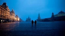 Two police officers patrol an almost empty Red Square, with St. Basil's Cathedral, center, and Spasskaya Tower and the Kremlin Wall, right, at the time when its usually very crowded in Moscow, Russia, Monday, March 30, 2020.