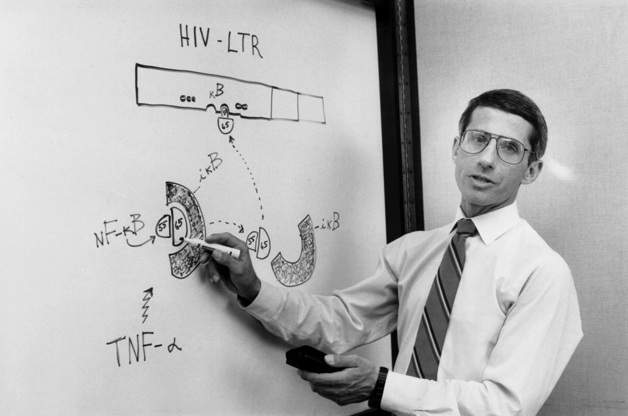 Fauci, as the chief of AIDS research at the National Institutes of Health, talks with colleagues in his laboratory in 1990.