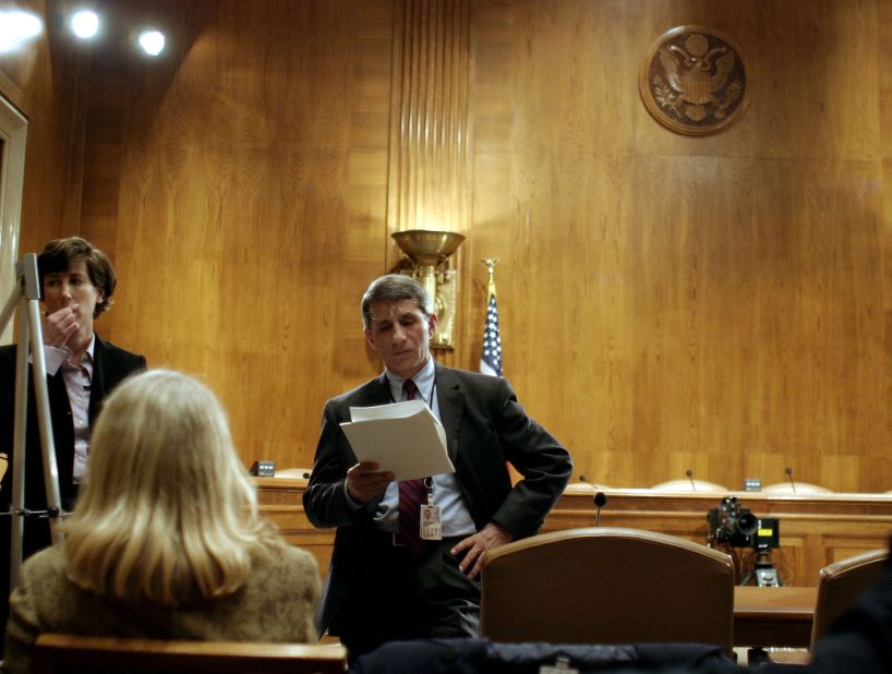 Fauci looks over his notes before testifying to a Senate committee about SARS in 2003.