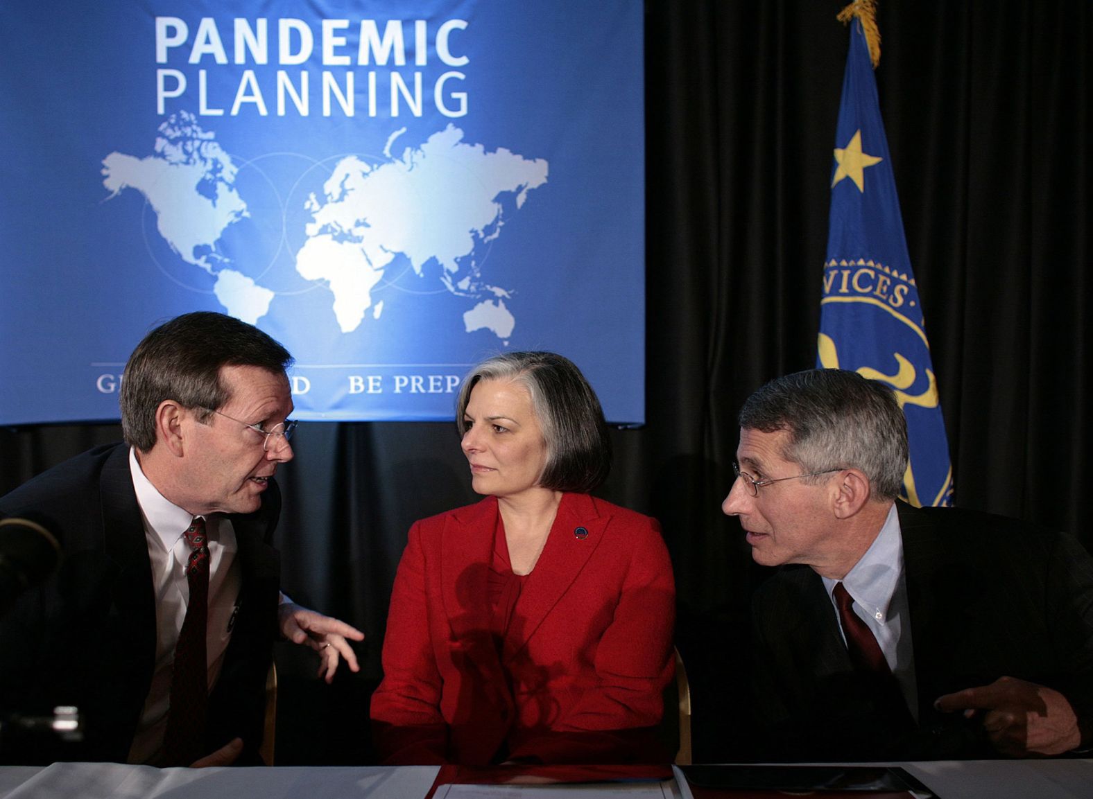 Fauci, right, speaks with Health and Human Services Secretary Mike Leavitt at a pandemic planning conference in Washington in 2005. At center is Dr. Julie Gerberding, director of the Centers for Disease Control and Prevention.