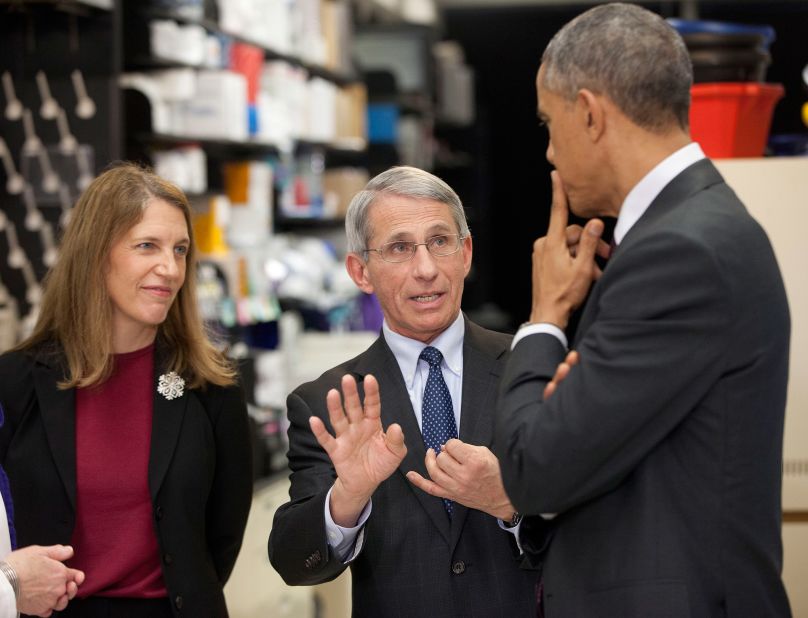 Fauci talks with President Barack Obama while Health and Human Services Secretary Sylvia Mathews Burwell looks on in 2014. It was during a tour of the Vaccine Research Center at the National Institutes of Health.
